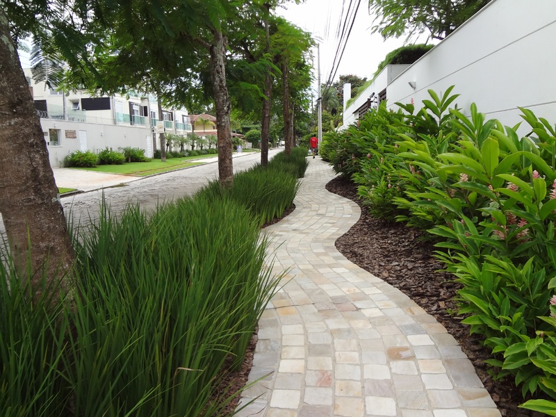 Landscaped paver path with grass and trees